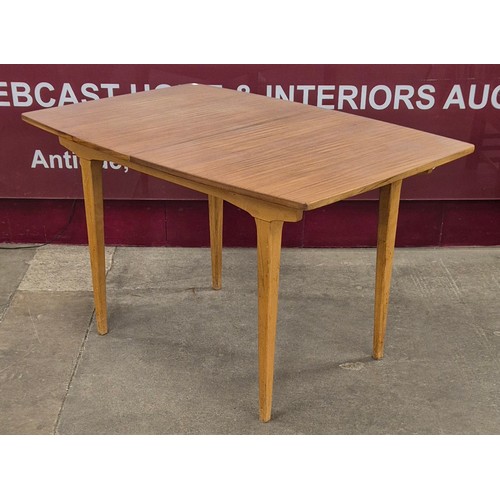 63 - A teak rectangular extending dining table