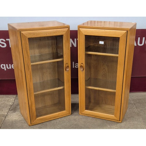 79 - A pair of Ercol Blonde ash wall hanging display cabinets