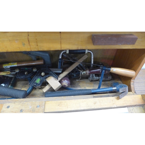 5055 - A wooden box of tools including saws, brace drill, sharpening stone, hammer, etc.