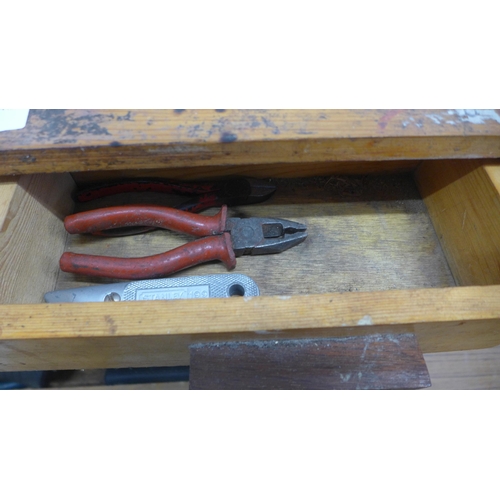 5055 - A wooden box of tools including saws, brace drill, sharpening stone, hammer, etc.