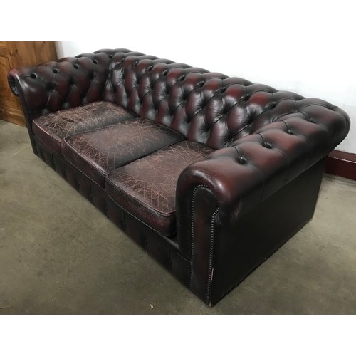 106 - A burgundy leather Chesterfield settee