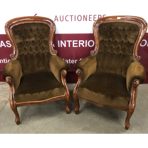 107 - A pair of Victorian mahogany and olive green fabric upholstered spoonback armchairs