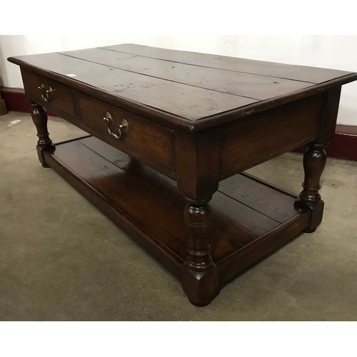 110 - An 18th Century style Ipswich oak four drawer coffee table