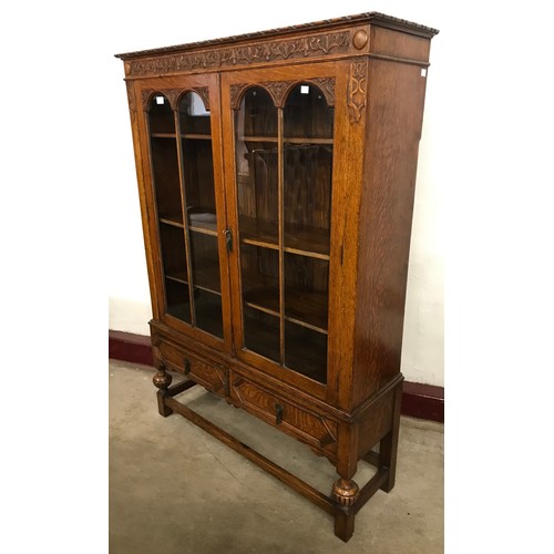 111 - An early 20th Century Jacobean Revival carved oak bookcase