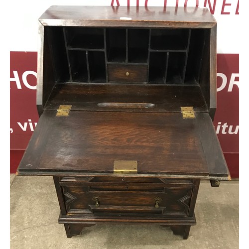 114 - An early 20th Century Jacobean Revival oak bureau