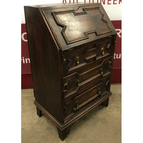 114 - An early 20th Century Jacobean Revival oak bureau