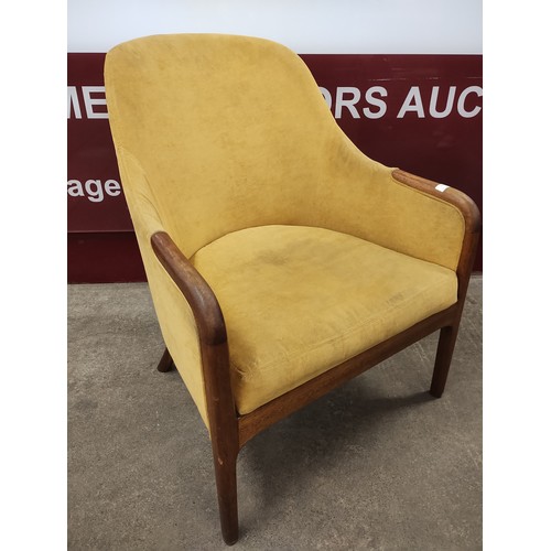 100 - A teak and mustard fabric armchair