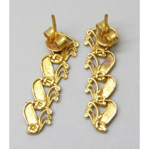 7010 - A pair of Eastern yellow metal earrings, 3.9g, 2.7cm drop