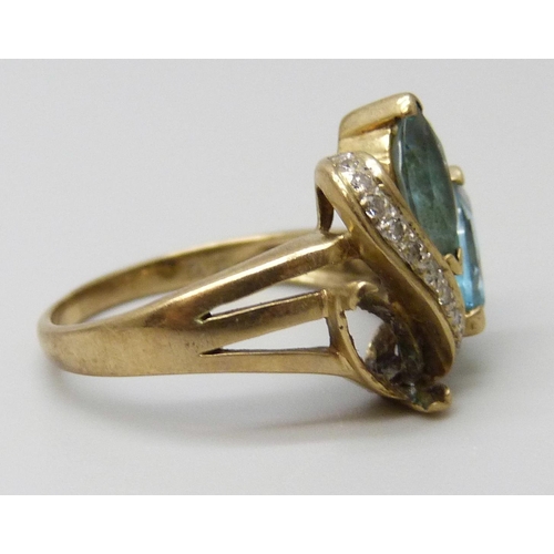 7023 - A 9ct gold ring set with topaz, one stone missing, 3g, K