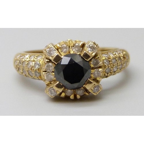 7027 - An 18ct gold and diamond ring, central black stone tests as a diamond, 4.2g, N, (one small diamond m... 