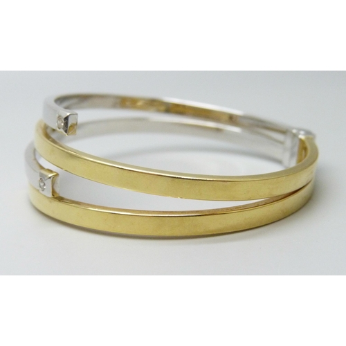 7032 - An Italian 18ct gold bangle, white/yellow gold set with white stones, spring hinge opening, 5.6 x 4.... 