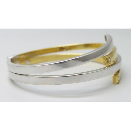 7032 - An Italian 18ct gold bangle, white/yellow gold set with white stones, spring hinge opening, 5.6 x 4.... 