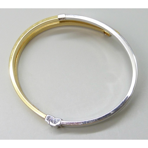 7032 - An Italian 18ct gold bangle, white/yellow gold set with white stones, spring hinge opening, 5.6 x 4.... 