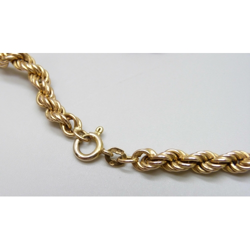 7036 - A 9ct gold rope chain necklace, 16.9g, 51cm