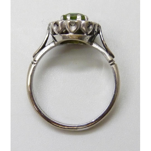 7050 - A white metal, peridot and diamond cluster ring, stamped 18ct, 4.9g, O