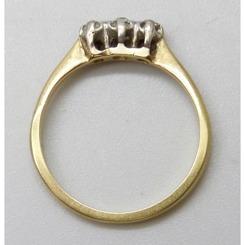 7061 - A yellow metal ring set with three diamonds, 1.9g, J