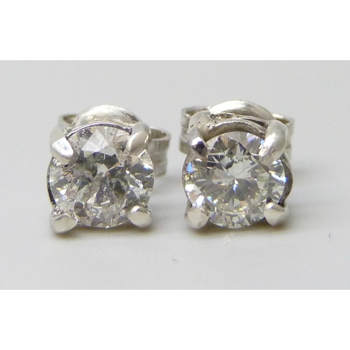 7066 - A pair of white metal diamond ear studs, approximately 1.30ct, a/f one back of setting split