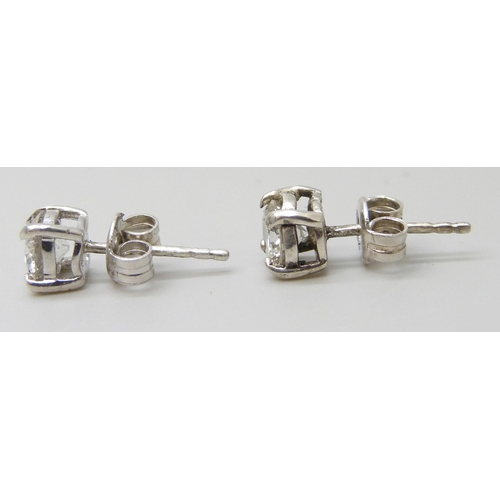 7066 - A pair of white metal diamond ear studs, approximately 1.30ct, a/f one back of setting split