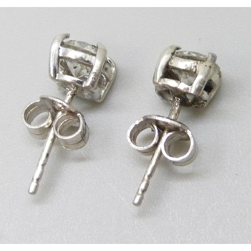 7066 - A pair of white metal diamond ear studs, approximately 1.30ct, a/f one back of setting split