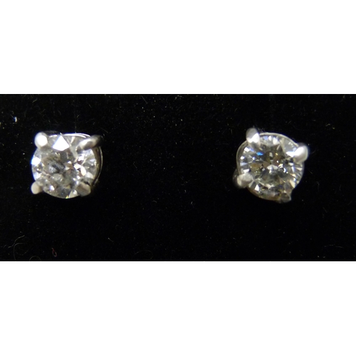 7066 - A pair of white metal diamond ear studs, approximately 1.30ct, a/f one back of setting split