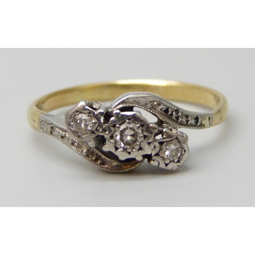 7069 - A yellow metal three stone diamond ring, stamped 18ct, 2.6g, N