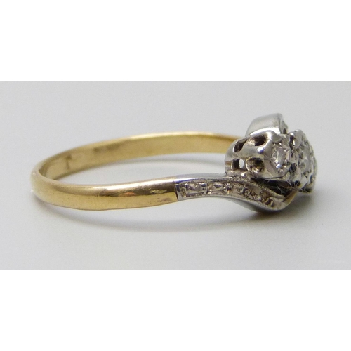 7069 - A yellow metal three stone diamond ring, stamped 18ct, 2.6g, N