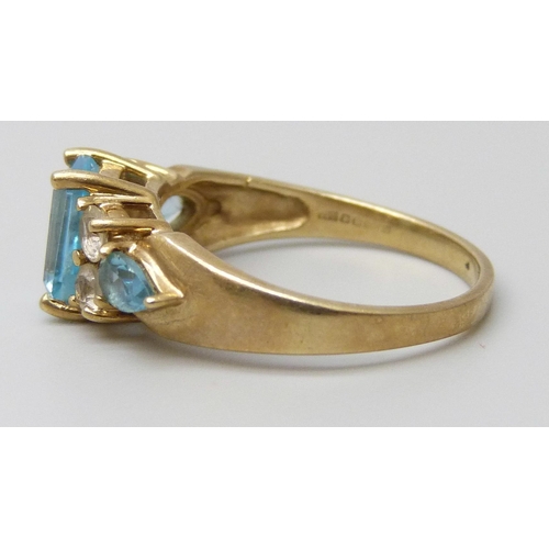 7083 - A 9ct gold, blue topaz and white stone ring, 3.5g, Q