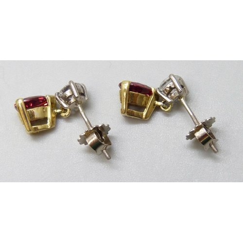 7087 - A pair of 18ct yellow and white gold claw set brilliant cut diamond and pendaloque cut ruby drop ear... 