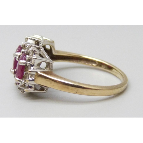 7088 - A 9ct gold, three stone ruby and diamond cluster ring, 3.2g, M