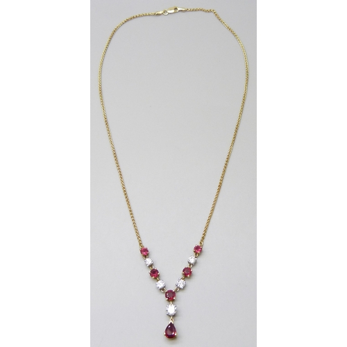 7089 - An 18ct yellow and white gold, ruby and diamond articulated necklet on a yellow gold spiga chain com... 