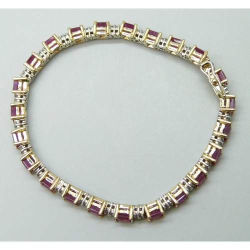 7090 - A 14k yellow and white gold claw set ruby and diamond line bracelet with box clasp and safety catch,... 