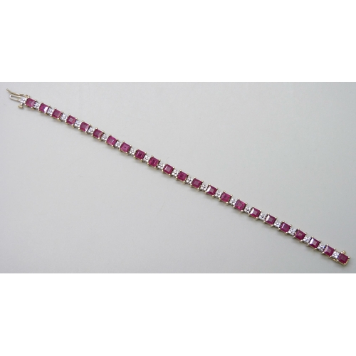 7090 - A 14k yellow and white gold claw set ruby and diamond line bracelet with box clasp and safety catch,... 