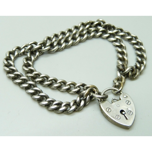 7094 - A silver double curb link bracelet with padlock clasp, 22g