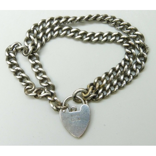 7094 - A silver double curb link bracelet with padlock clasp, 22g