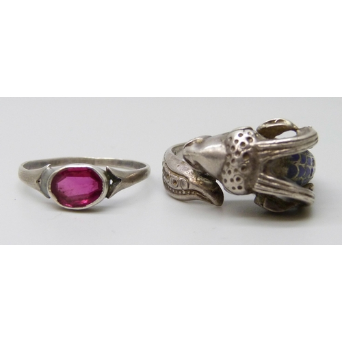 7095 - A .800 silver and enamel ram's head ring, R/S, and a repaired white metal ring set with a pink stone... 