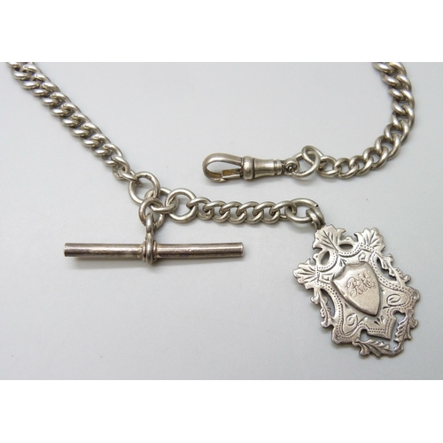 7103 - A silver curb link watch chain with a silver fob, 51g, 30cm to T bar including clip