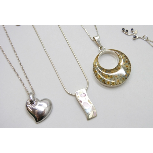 7114 - A collection of silver jewellery including charms, earrings, a St Christopher pendant, and necklaces