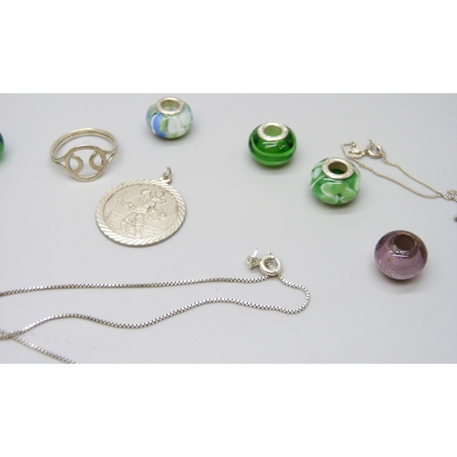 7114 - A collection of silver jewellery including charms, earrings, a St Christopher pendant, and necklaces