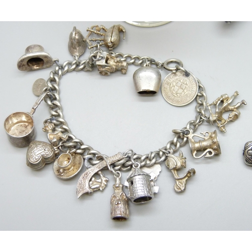 7115 - Silver charm bracelet with silver and white metal charms, 51g, another silver bracelet with plated a... 