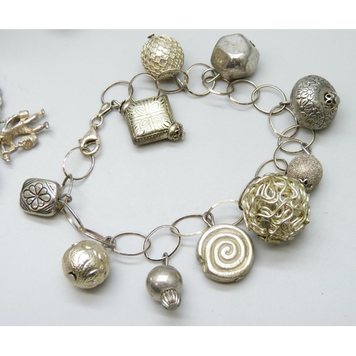 7115 - Silver charm bracelet with silver and white metal charms, 51g, another silver bracelet with plated a... 