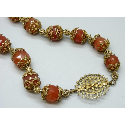 7126 - An Art Deco faceted carnelian necklace, 56cm