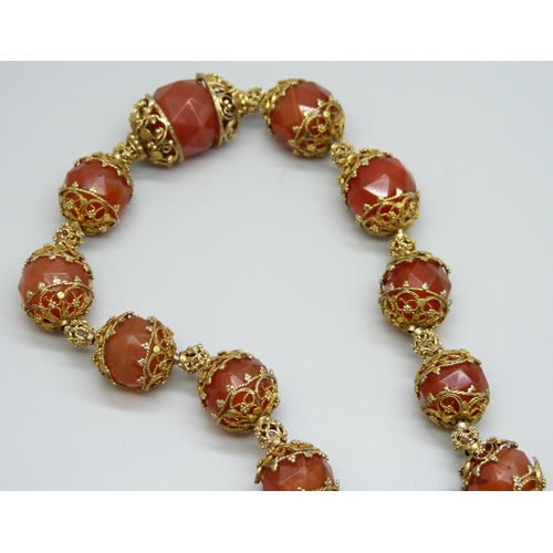 7126 - An Art Deco faceted carnelian necklace, 56cm