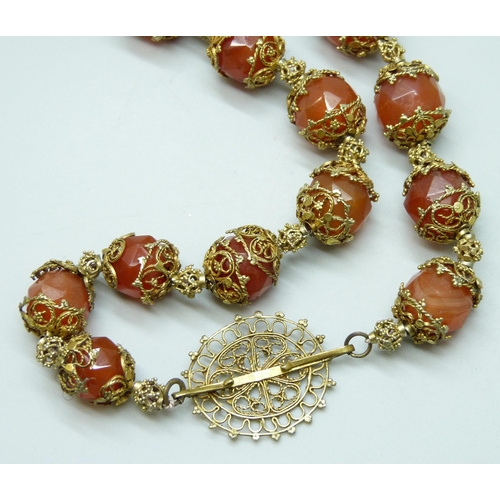 7126 - An Art Deco faceted carnelian necklace, 56cm