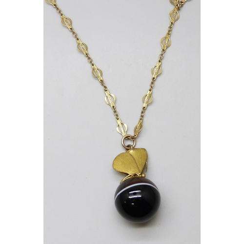 7129 - A large banded agate spherical pendant with butterfly mount, on a fancy link chain