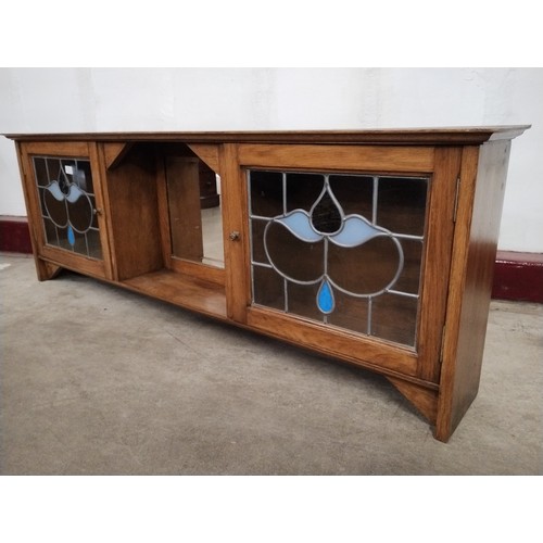 158 - An Arts & Crafts walnut and stained glass two door wall hanging cabinet