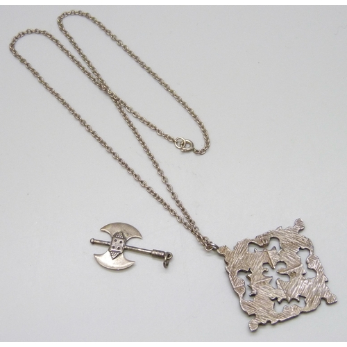 7133 - A silver Brutalist style pendant on chain, together with a silver axe pendant, 19g total