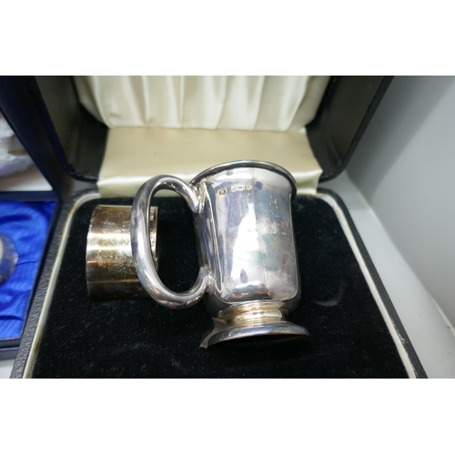 7151 - A silver christening cup and napkin ring set, lacking spoon, a silver pot, 159g total weight, a pair... 