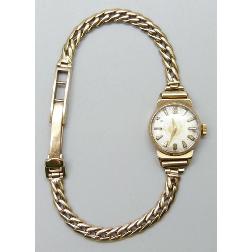 7180 - A 9ct gold lady's wristwatch on a 9ct gold strap, 15.4g total weight including movement