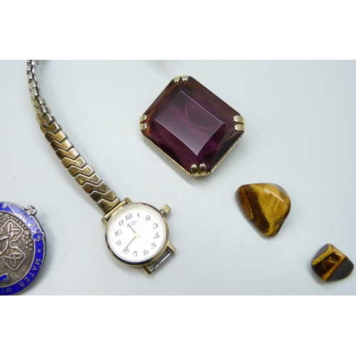 7182 - A collection of jewellery including a silver enamelled brooch, a gold plated Victorian locket, tiger... 