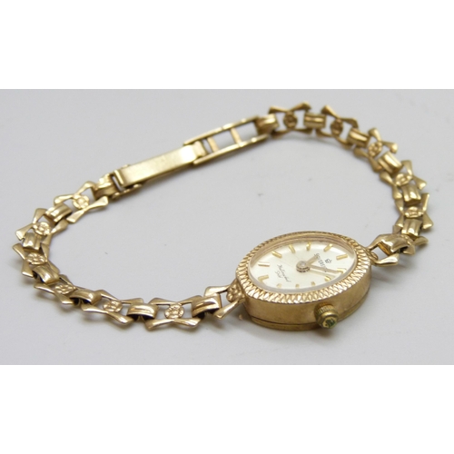 7185 - A 9ct gold lady's wristwatch on a 9ct gold strap, 8.1g total weight